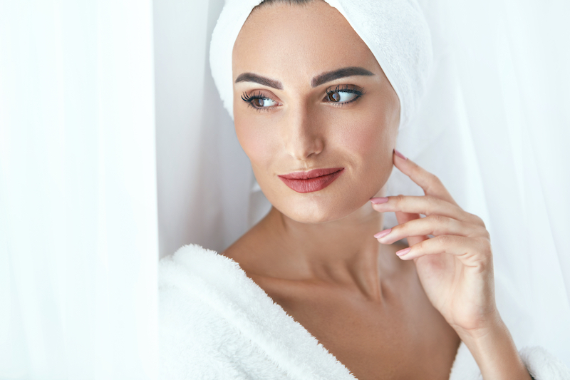 Woman wearing bath towel on hair after showering