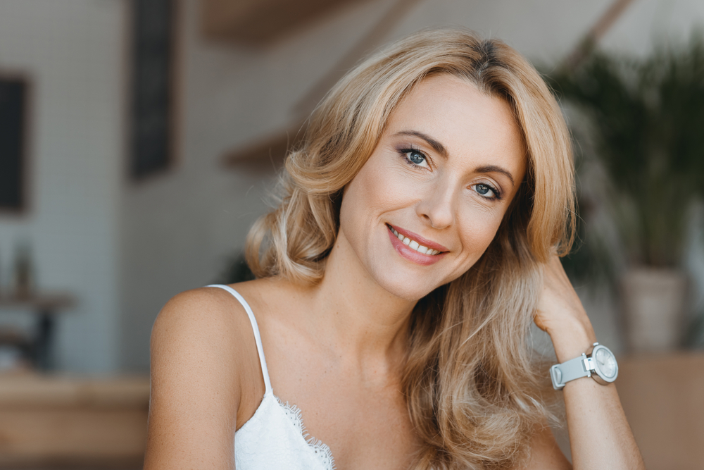 portrait of beautiful happy middle aged woman smiling at camera.