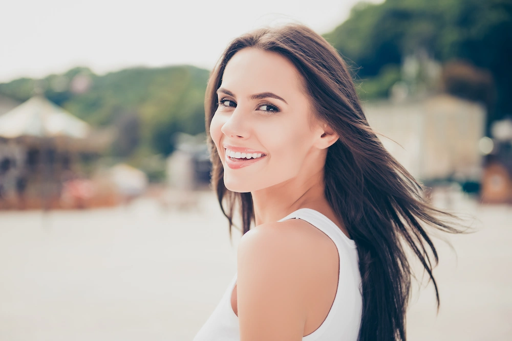 Pretty 30s woman smiling outside
