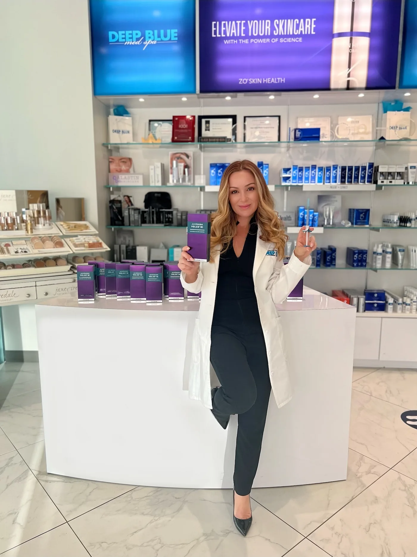 Lead PA Melissa Colletti-White posing with JUVÉDERM<sup>®</sup> VOLUX<sup>™</sup> XC inside Deep Blue Med Spa