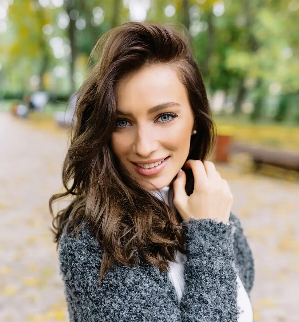 Beautiful woman in park looking at camera