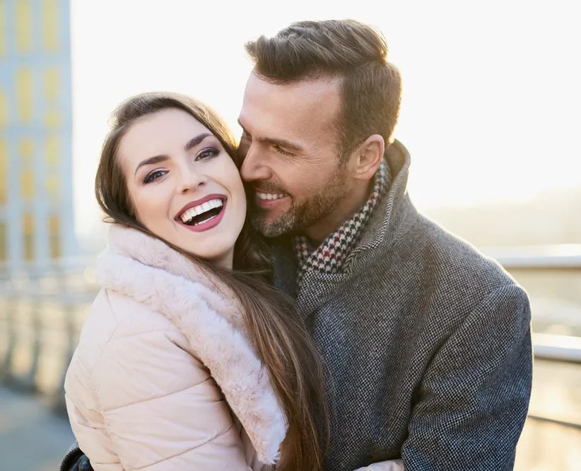 beautiful couple smiling during sunset