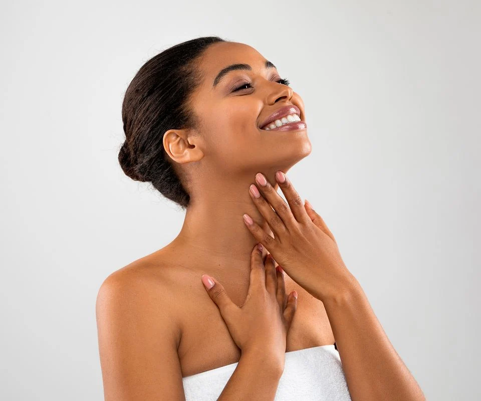 Beautiful woman admiring her smooth skin