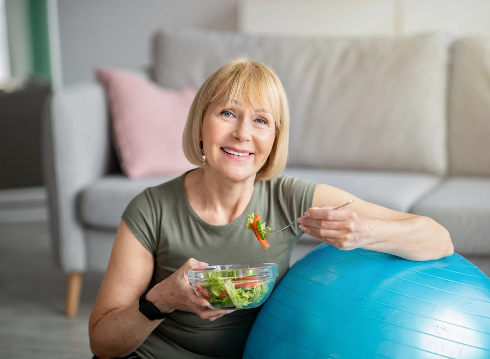 mature woman eating healthy after workout
