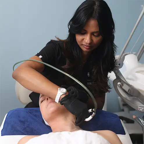 woman getting facial laser treatment