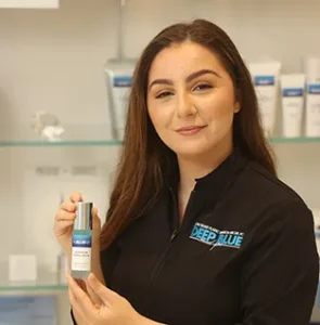 Alexandria DeFeo, Medical Aesthetician holding ProBlueMD product