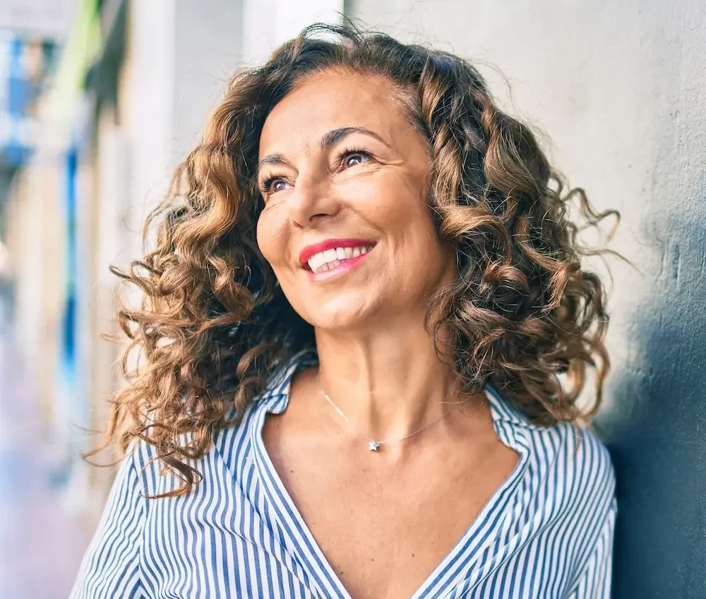 mature woman stopping to pose in the city