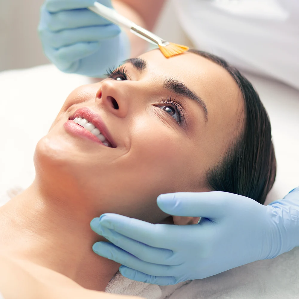 woman enjoying chemical peel treatment on face