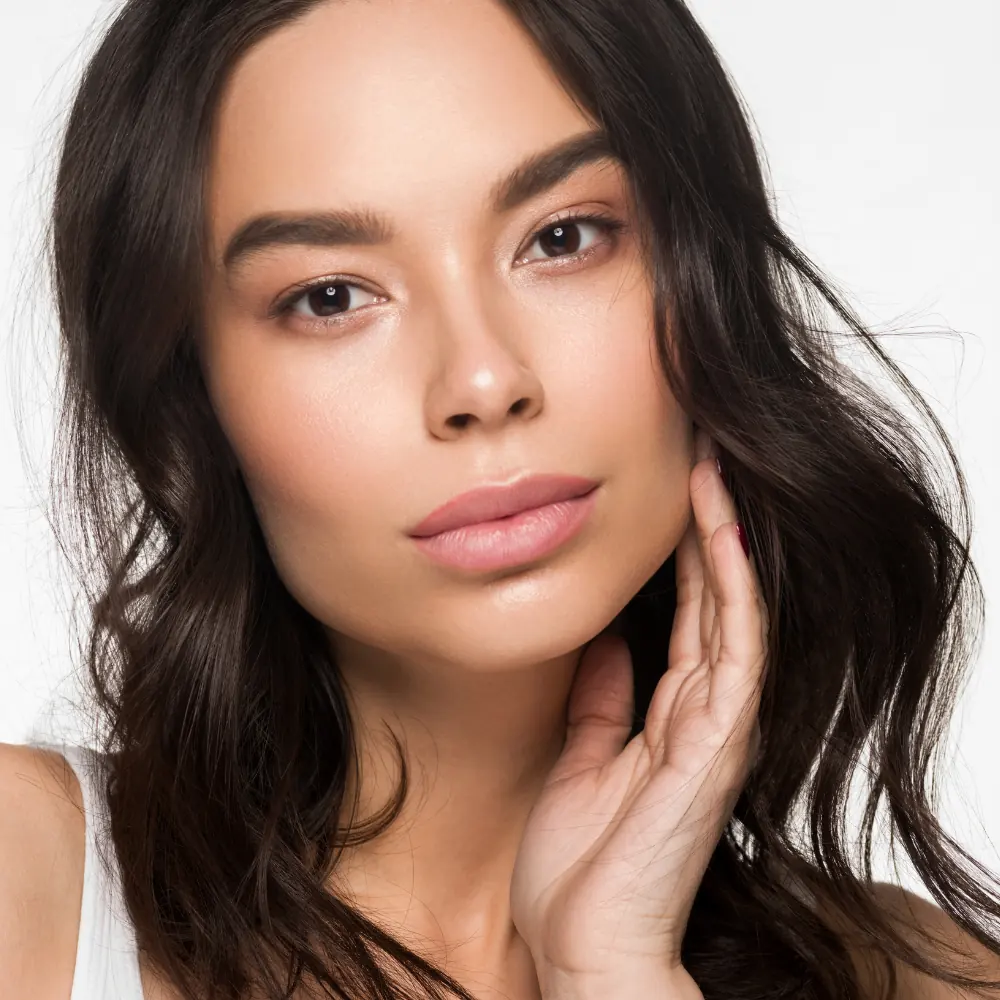 confident young woman touching clear skin