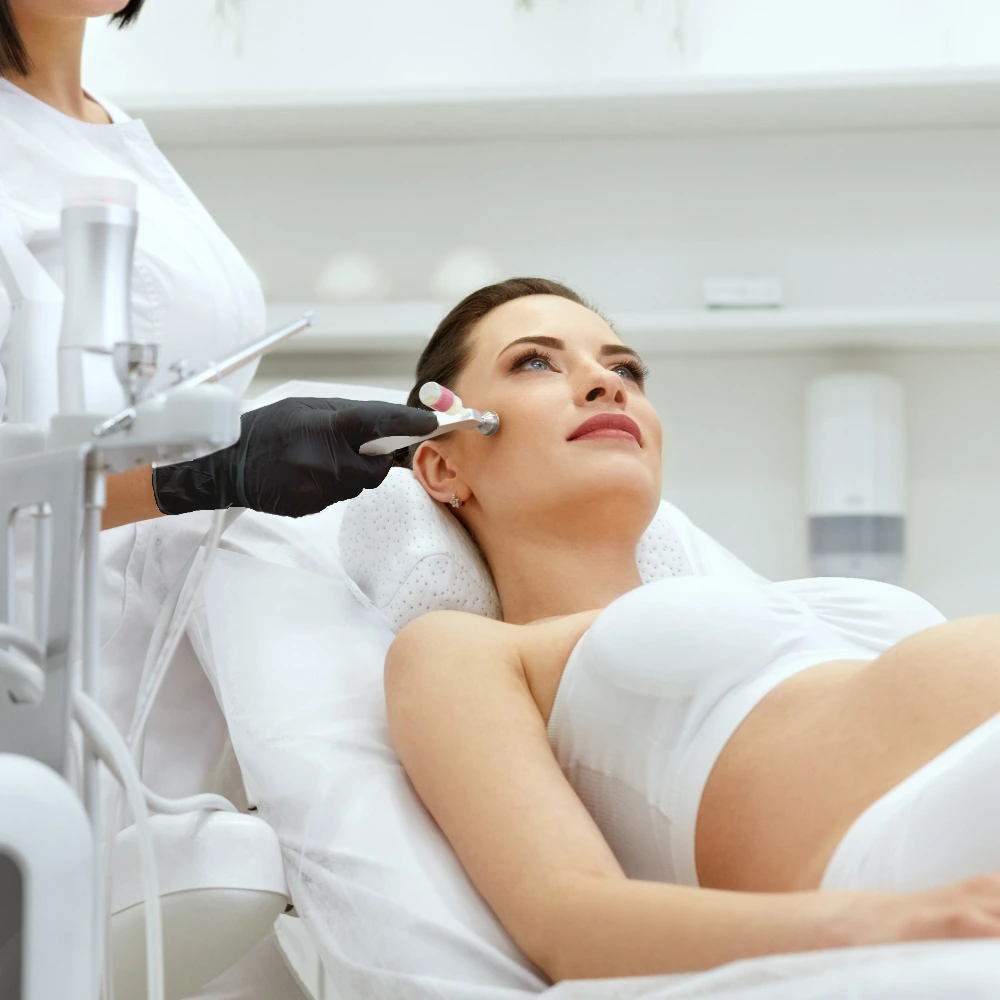 pregnant woman getting aesthetic treatments on face