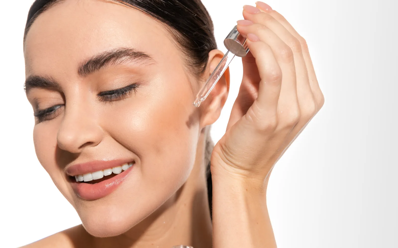 Woman using hydrating serum skincare product