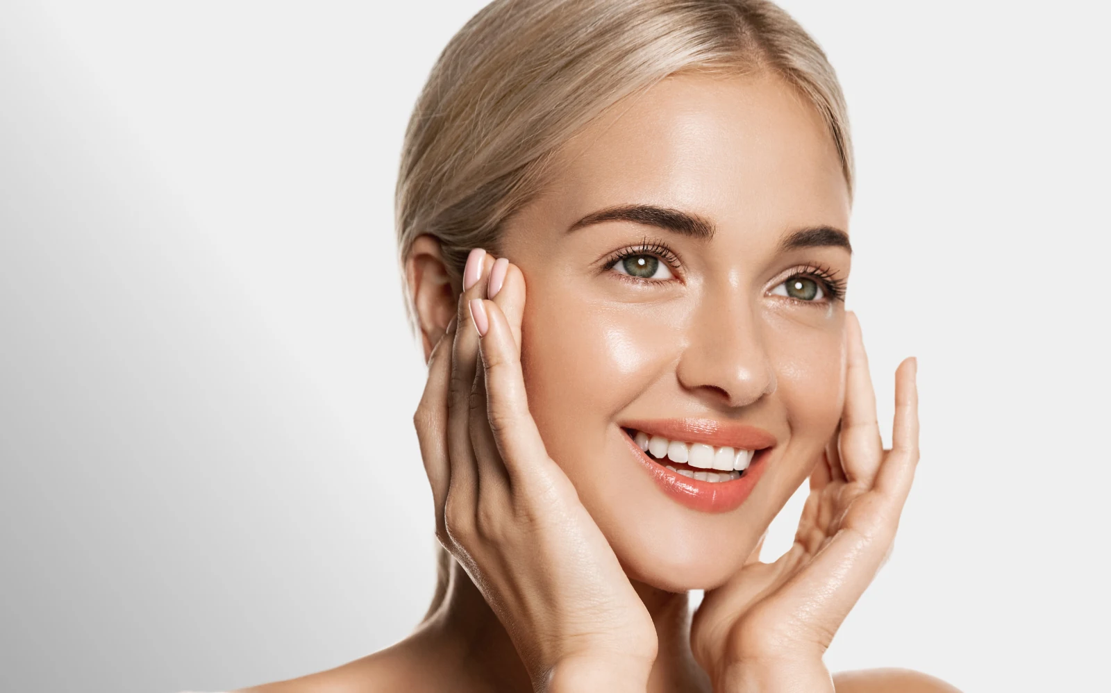 youthful woman touching healthy, hydrated skin