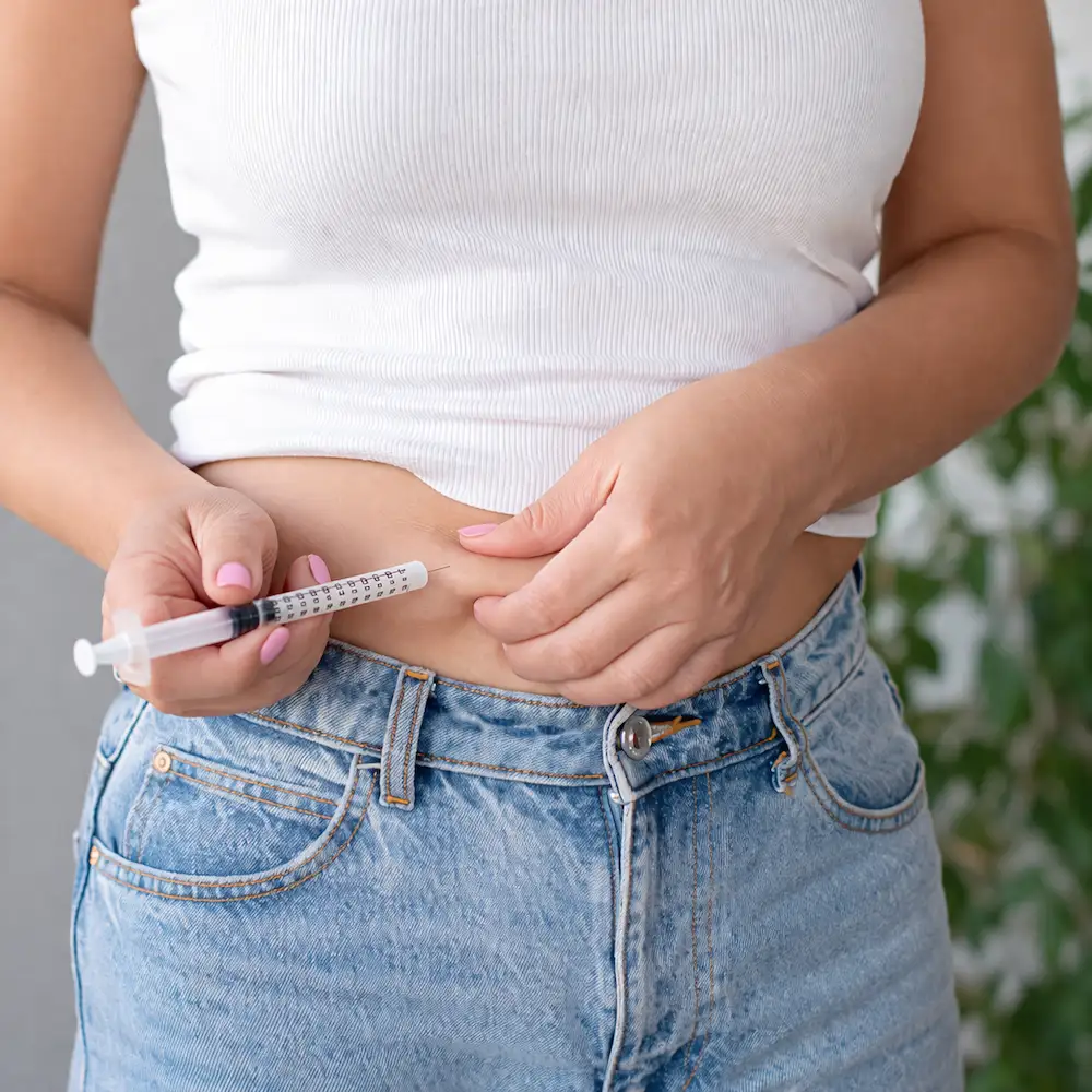 woman giving herself a glp-1 shot for weight management