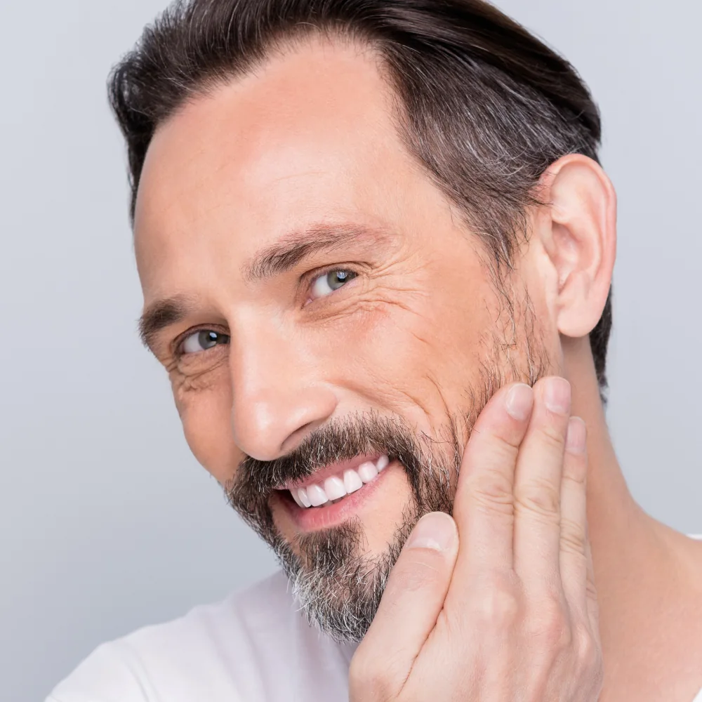 attractive mature man touching face showing clear skin