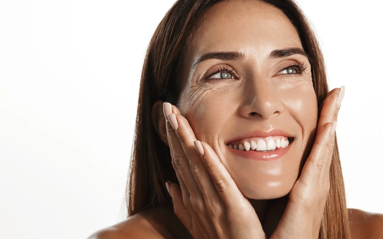 gorgeous middle-aged woman touching healthy smooth skin