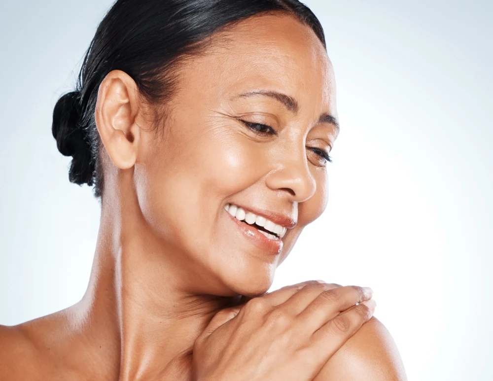 mature woman touching soft, radiant skin