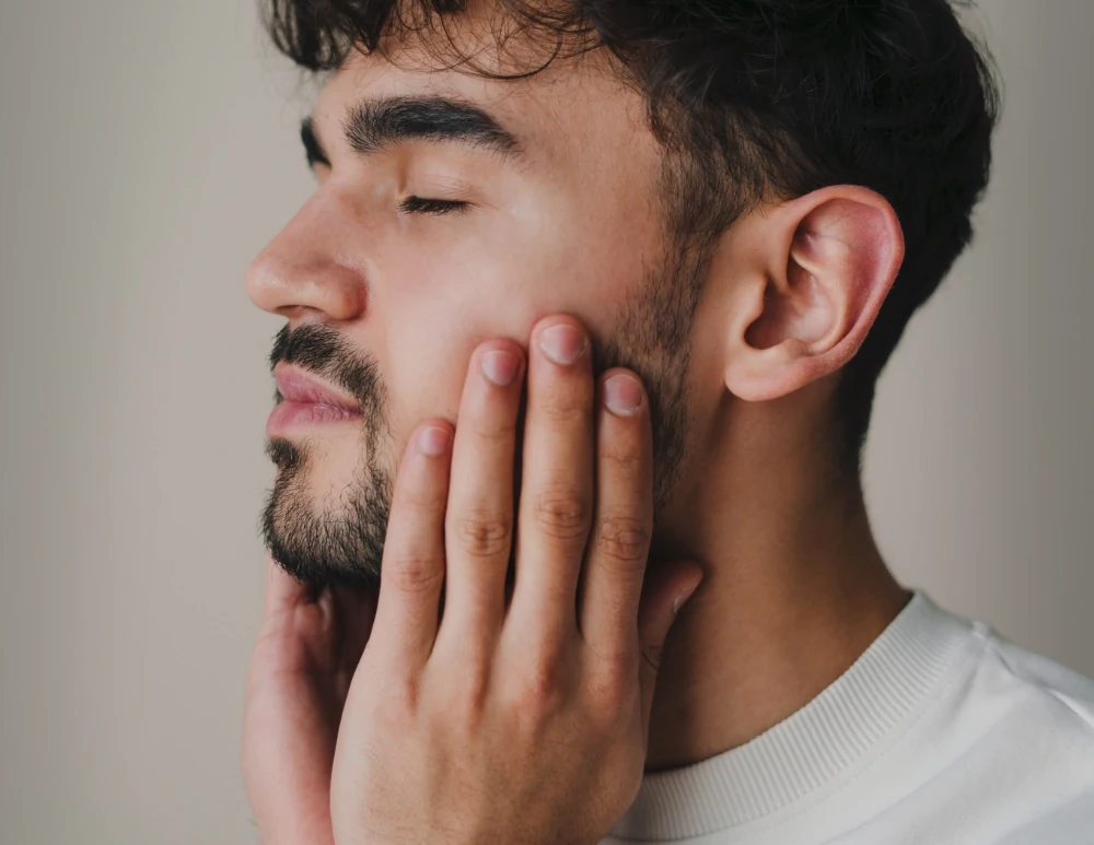 young man touching clear skin