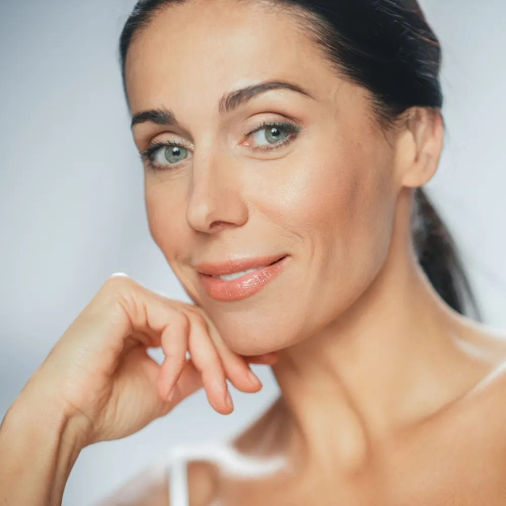 Middle age woman with glowing skin after Glo2Facial
