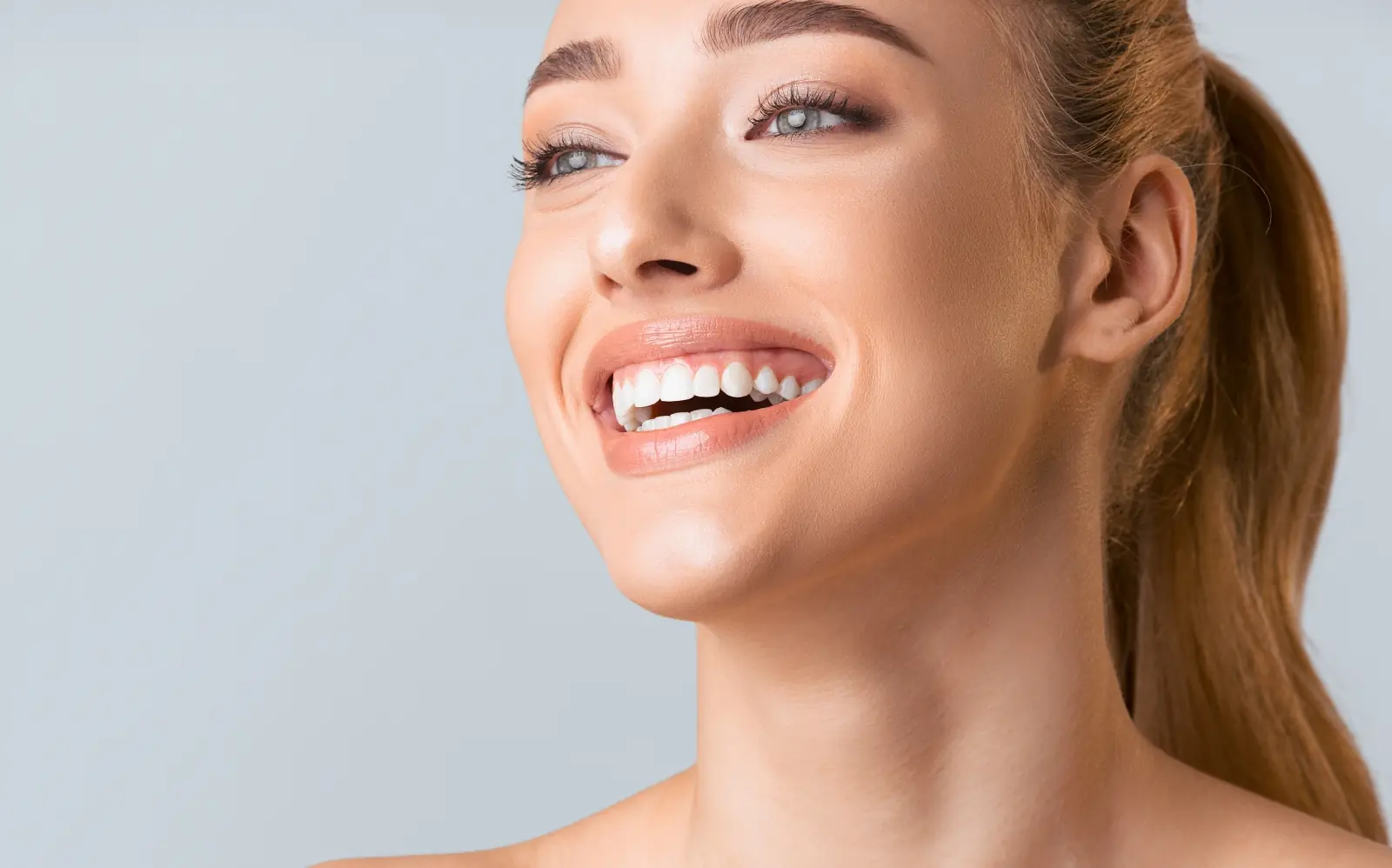 Beautiful woman smiling with glowing skin